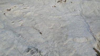 Drone view of Pamukkale travertines, natural beauty consisting of waterfalls and swimming pool with white minerals in Turkey shoot by drone