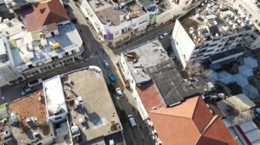 Aerial drone view of the streets of the city of Kyrenia and the layout of the buildings, the traffic flow on the street, the streets made up of apartment blocks in TRNC
