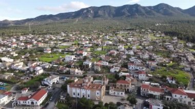 Aerial drone view of Esentepe, the city of Cyprus, layout of cities on the island, aerial view of buildings and streets, city with mountain and sea view