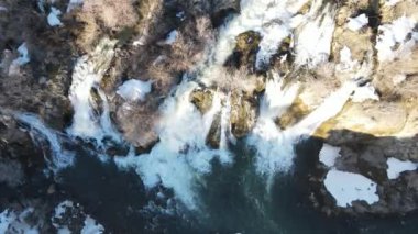 Drone view of the water flowing through the stones in the autumn season, the beauty of the water flowing from the waterfall in the streambed