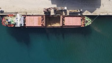 Drone view of loading ship on cyprus port, container transport of freighter, view of red freighter for maritime trade in famagusta port