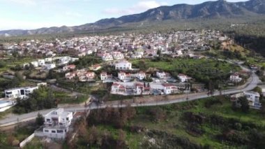 Aerial drone view of Esentepe, the city of Cyprus, layout of cities on the island, aerial view of buildings and streets, city with mountain and sea view