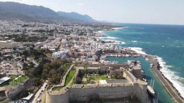 Inside the walls of the historical castle built by the sea, Kyrenia castle taken by drone from the air, Girne protected by the castle walls