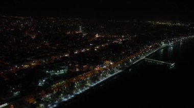 Drone view of the coastal city in the night, image with night lights in the coastal city, the city illuminated by the street lamps