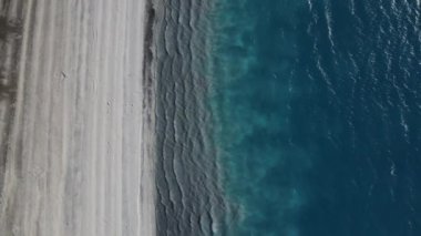 Aerial drone footage of volcanic lake salda, famous crater lake salda with water waves and white beach, tectonic lake regions in Turkey