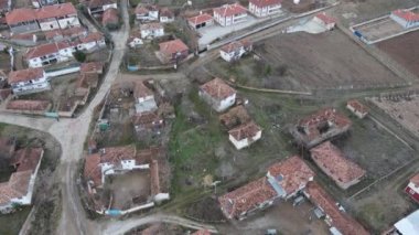 Aerial drone view of small village, small population tile roofed houses, rural life village houses roofs, settlement in rural village in autumn