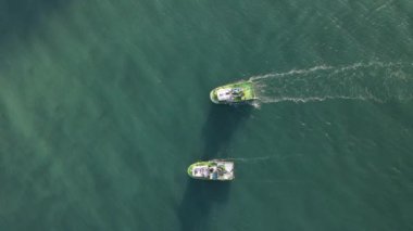 Aerial drone view of the white ship fishing in the lake, fishermen in the waters when the season starts, fishermen hunting in the middle of the sea