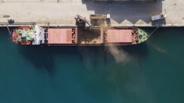 Drone view of loading ship on cyprus port, container transport of freighter, view of red freighter for maritime trade in famagusta port