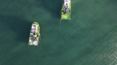 Aerial drone view of the white ship fishing in the lake, fishermen in the waters when the season starts, fishermen hunting in the middle of the sea