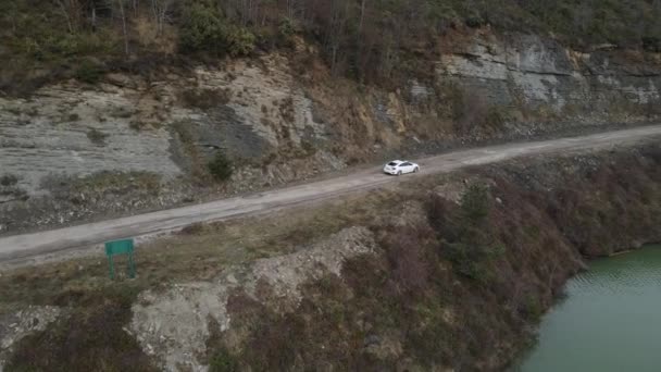 Drone View White Car Passing Dirt Road Dam Forest Park — Stockvideo