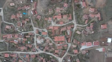 Aerial drone view of small village, small population tile roofed houses, rural life village houses roofs, settlement in rural village in autumn