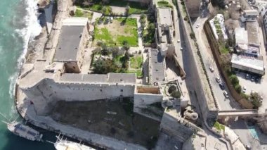 Inside the walls of the historical castle built by the sea, Kyrenia castle taken by drone from the air, Girne protected by the castle walls