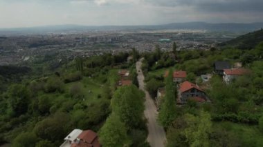 Aerial green city Bursa, beautiful view of green bursa, bursa city settlement in green nature, settled city in the wide valley, green turkish city living together with the climate crisis