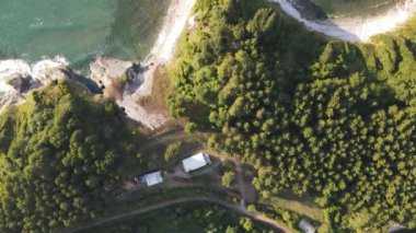 Campsite In Bay, beach among green trees, cliffs stretching towards the sea, summer holiday coves with turquoise sea waters