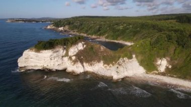 Drone view seaside cliffs, naturally formed cliffs on the coast, sea under green land, Turkeys coastal beauties, nature tourism venues