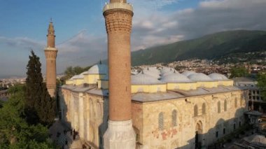 Bursa grand mosque architecture, architectural structure of islamic place of worship with minarets and domes, touristic important mosque made of stone