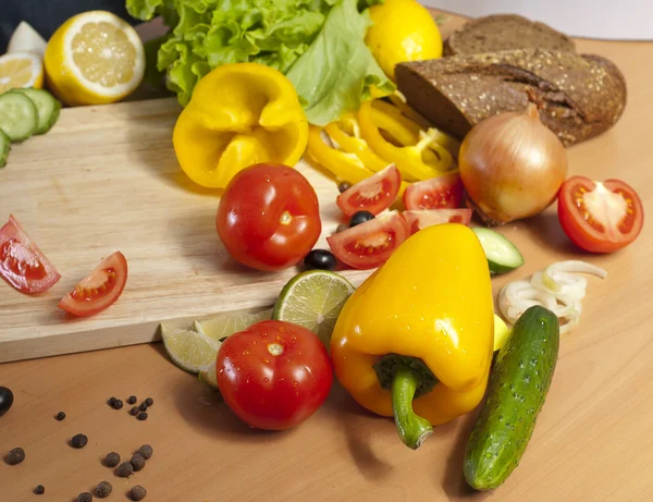 Peppers surrounded by vegetables — Stock Photo, Image