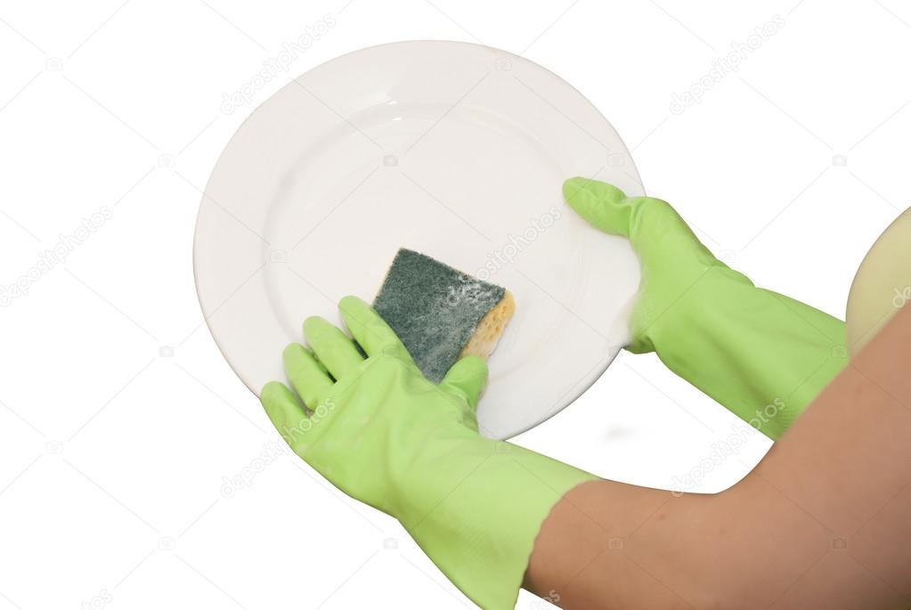 Hands in green gloves wash white plate