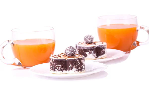 Two cake on plates with juice on white isolated — Stock Photo, Image