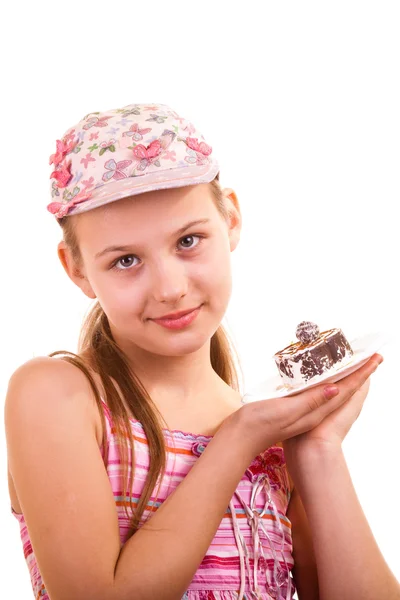 Csinos, fiatal lány látszó-nél torta fehér háttér — Stock Fotó