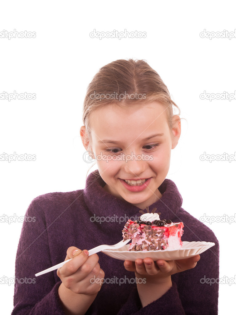 Pretty young girl looking at cake on white background