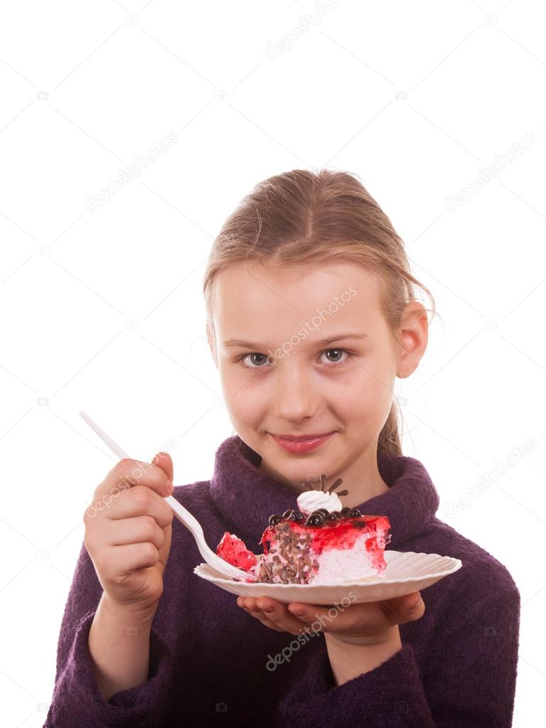Pretty young girl looking at cake on white background