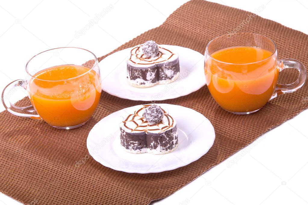 Two cake on plates with juice on white isolated