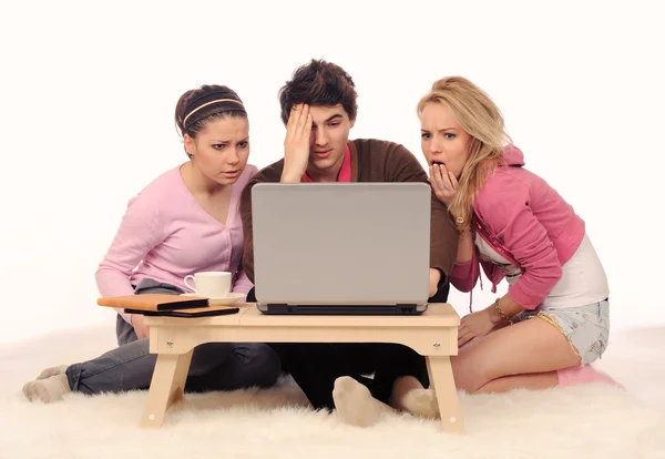 Frightened friends with laptop. — Stock Photo, Image