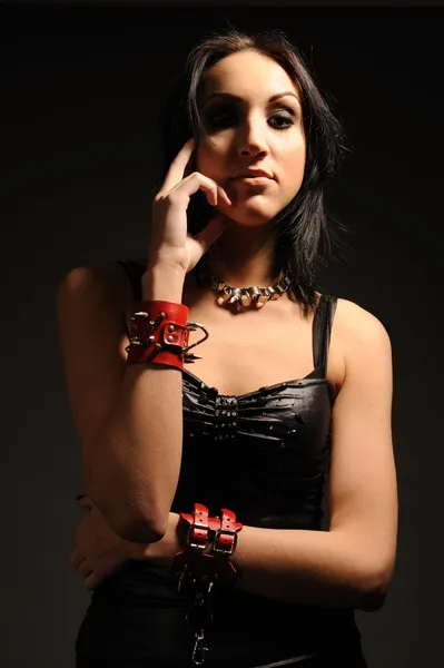 Girl in red handcuffs — Stock Photo, Image