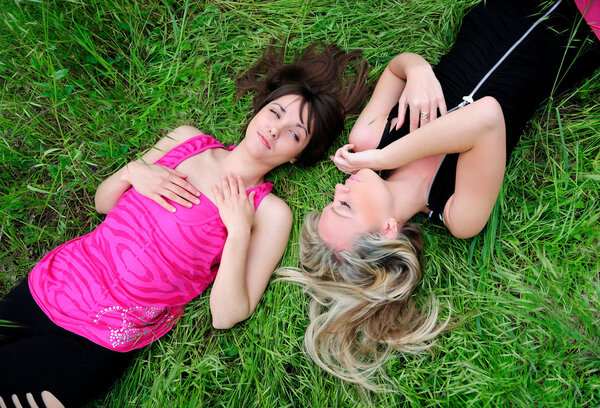 girls laying in grass