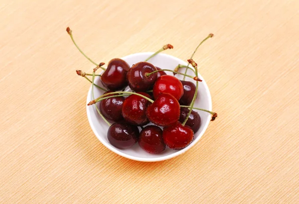 Cup of cherries on a background — Stock Photo, Image