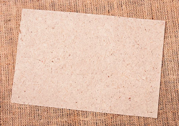 Burlap and paper background — Stock Photo, Image