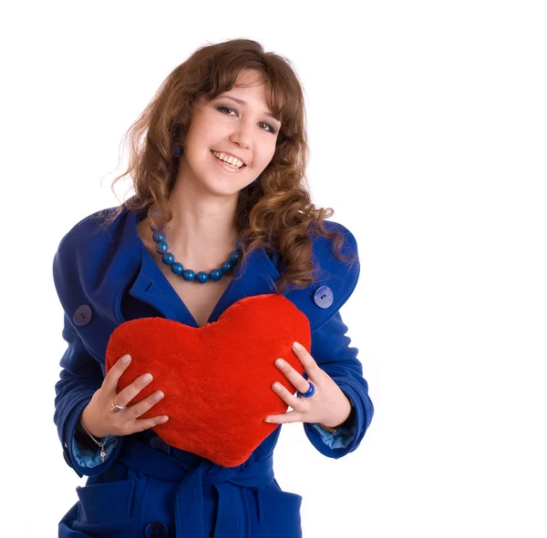 Beautiful young woman with heart pillow — Stock Photo, Image