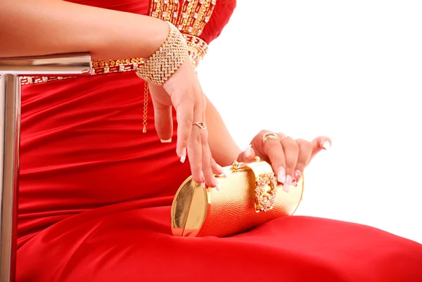 Niña en vestido rojo con bolsa de oro — Foto de Stock