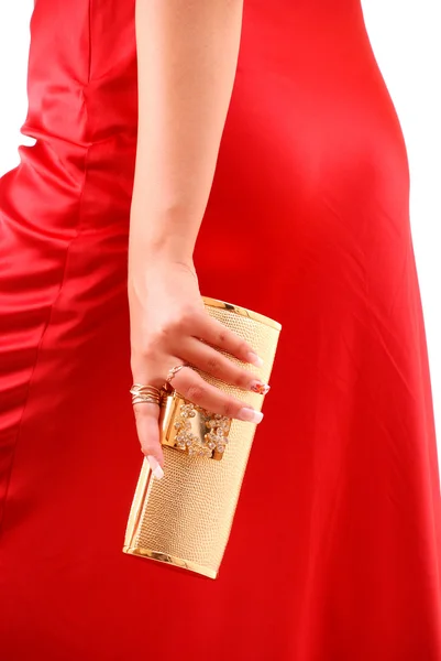 Hand met een gouden handtas — Stockfoto