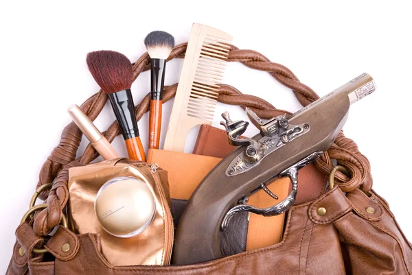 Handbag with cosmetics and pistol — Stock Photo, Image