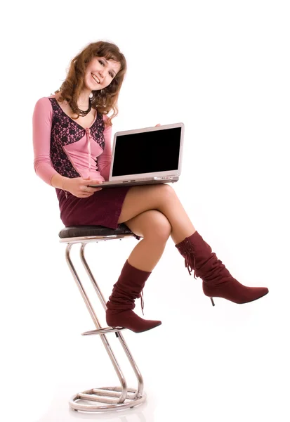 Smiling young woman working on laptop Stock Picture