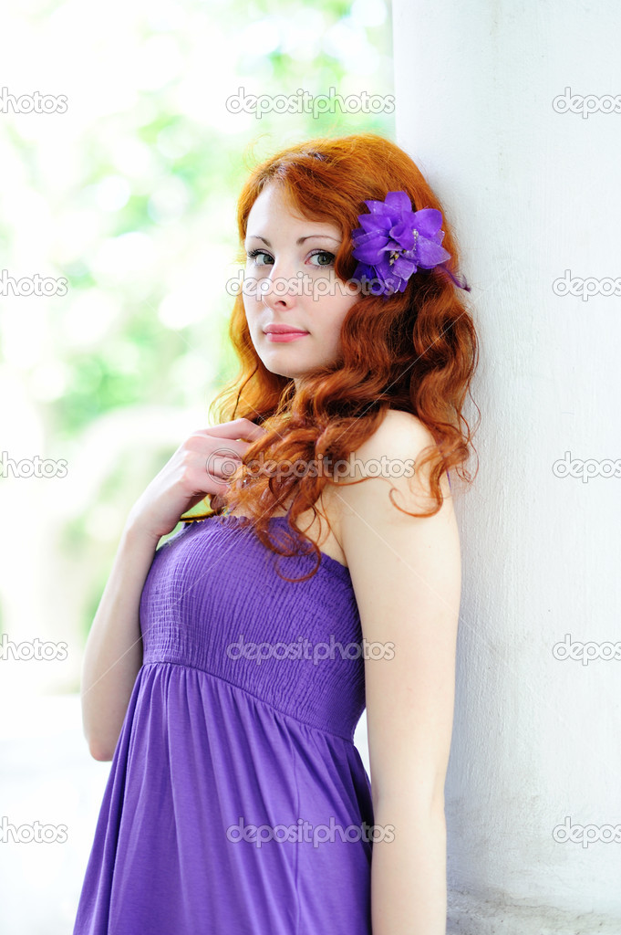 Young woman portrait with flower in her hair.