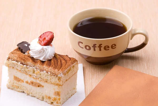 Pastel con taza de café y libro — Foto de Stock