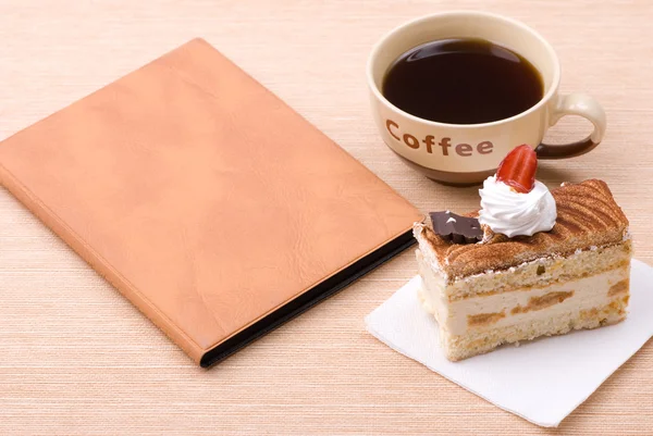 Cake with cup of coffee and book — Stock Photo, Image