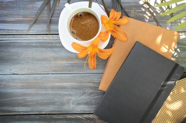 Morning mock up with coffee and notebooks on a wooden table, flat lay, outdoor