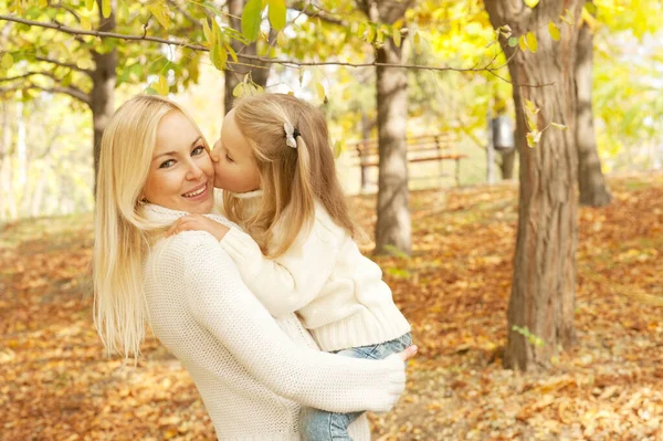 Cute Happy Daughter Kissing Her Mother Cheek Autumn Park — Stok fotoğraf