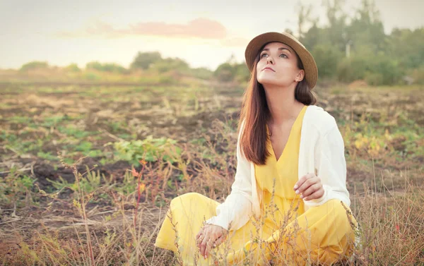 Beautiful young sad woman portrait against sunset autumn field, outdoor, seasonal depression