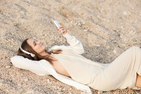 Smiling Woman Lying Sea Sand Listening Music White Phone — Stock fotografie