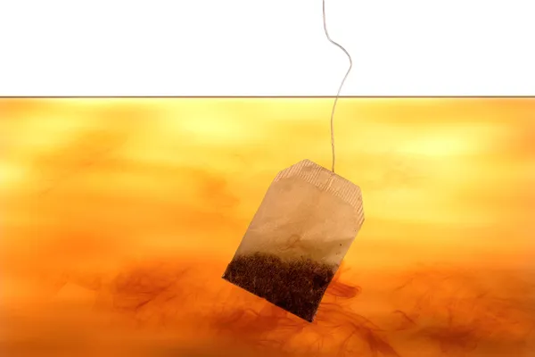 Tea bag in water — Stock Photo, Image