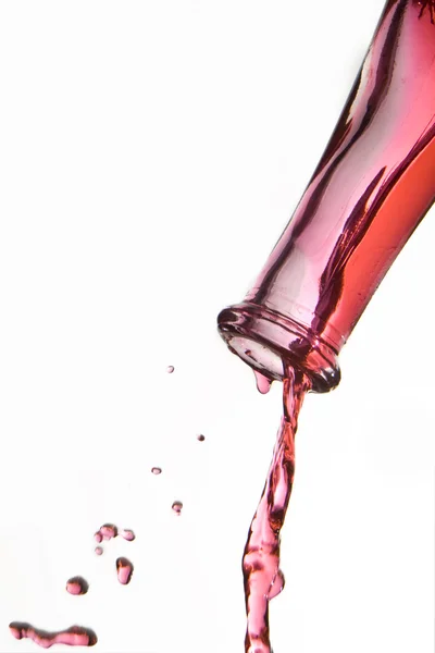 Red wine pouring from bottle — Stock Photo, Image