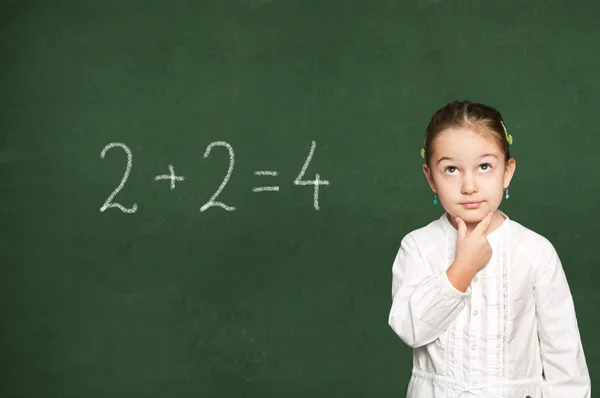 Smart girl thinking, chalkboard background — Stock Photo, Image