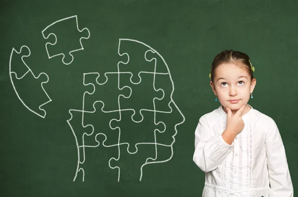 Puzzle in head on chalkboard — Stock Photo, Image