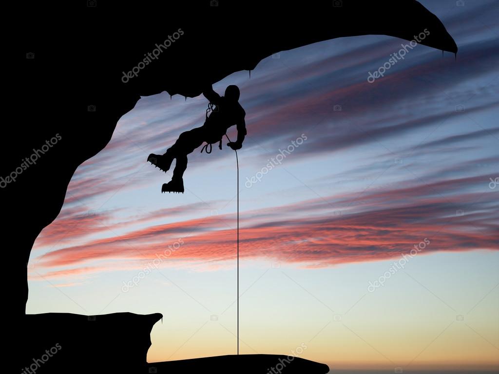 Mountain climber hanging on a rope on the background of sky — Stock