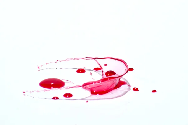 Glossy red liquid droplets (splatters) isolated on white — Stock Photo, Image